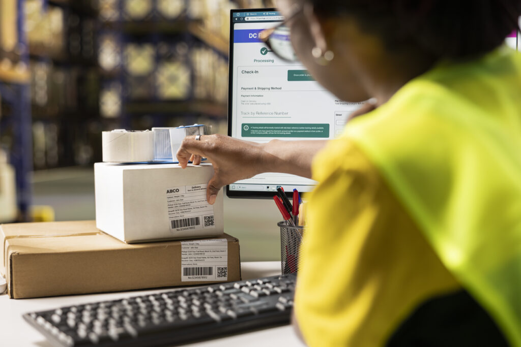 African american female verifying the shipment details on awb labels